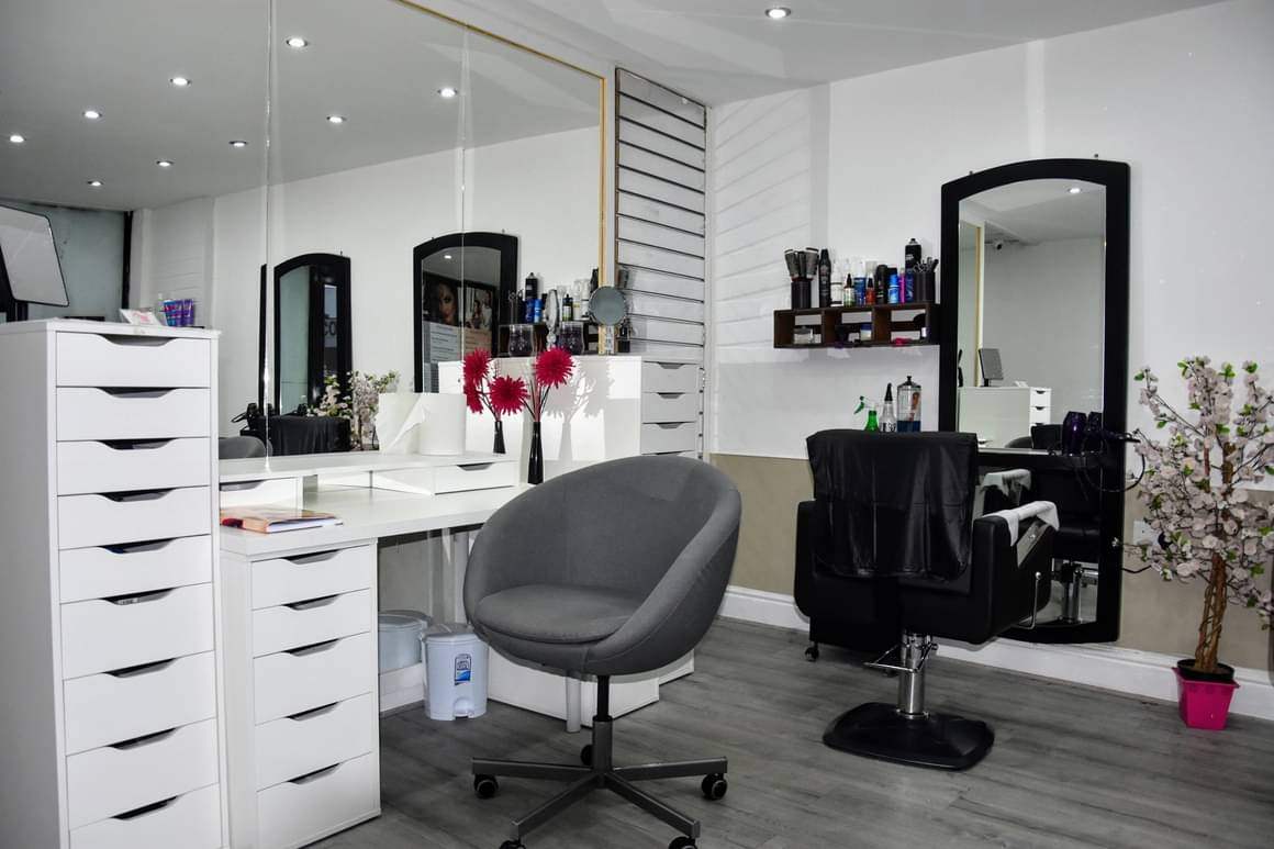 Inside Pretty Woman salon on Slade Lane: white dressers, tall black mirrors and a styling chair